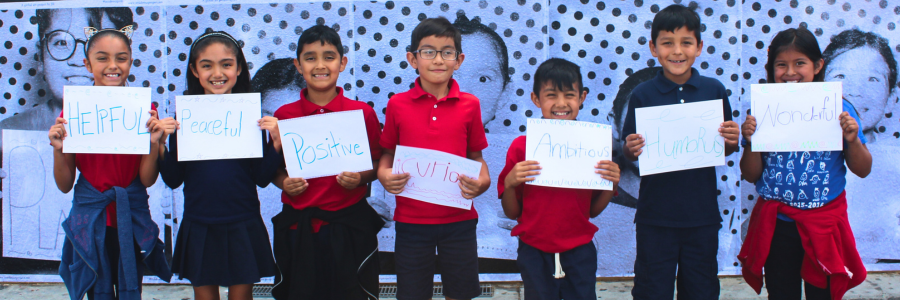 Students holding up nice signs that they created