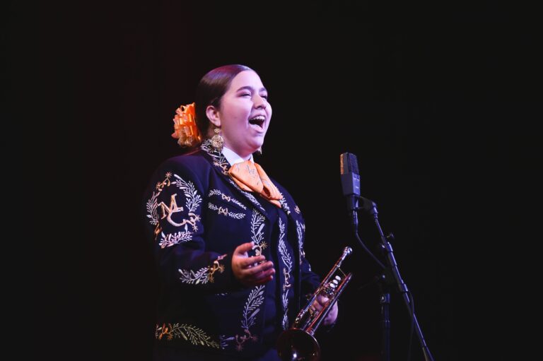 Student standing in front of a microphone and singing